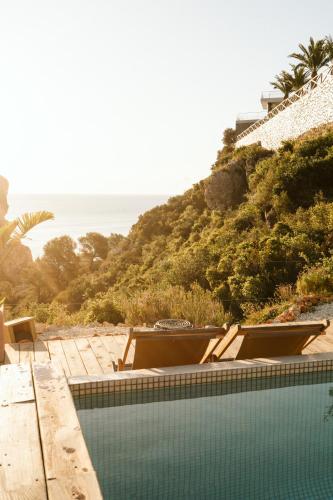 a swimming pool with a view of the ocean at Dreamsea Mediterranean Camp in Benitachell