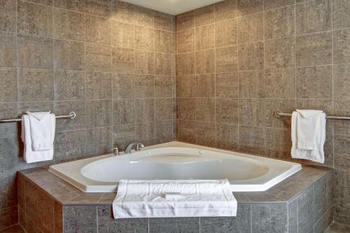 a large bath tub in a bathroom with towels at Hampton Inn Sudbury, Ontario in Sudbury