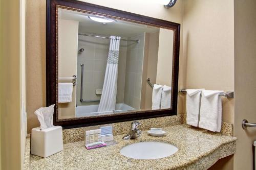 a bathroom with a sink and a mirror at Hampton Inn Sudbury, Ontario in Sudbury