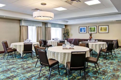 a conference room with tables and chairs and a chandelier at Hampton Inn Sudbury, Ontario in Sudbury