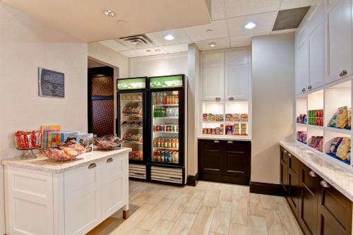 a grocery store aisle with a counter and a refrigerator at Homewood Suites by Hilton Toronto Mississauga in Mississauga