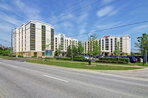 an empty street with two large white buildings at Homewood Suites by Hilton Toronto Airport Corporate Centre in Toronto