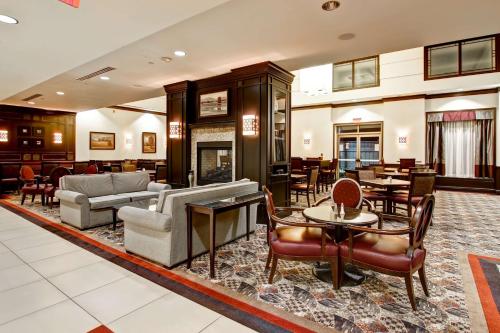 a lobby with chairs and tables and a living room at Homewood Suites by Hilton Toronto Airport Corporate Centre in Toronto