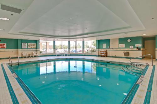 a large swimming pool with blue water at Homewood Suites by Hilton Toronto Airport Corporate Centre in Toronto