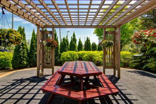 a picnic table under a pergola on a patio at Hampton Inn by Hilton Toronto Airport Corporate Centre in Toronto