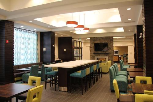 a dining room with a long table and chairs at Hampton Inn by Hilton Winnipeg in Winnipeg