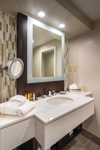 a bathroom with a sink and a large mirror at Grand Traverse Resort and Spa in Traverse City