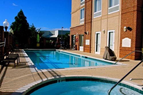 a large swimming pool in front of a building at Hilton Garden Inn Albany in Albany