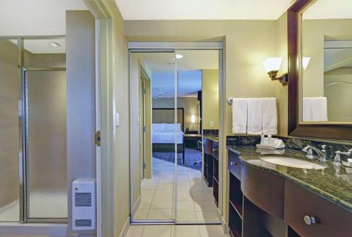 a bathroom with two sinks and a shower at Homewood Suites by Hilton Cambridge-Waterloo, Ontario in Cambridge