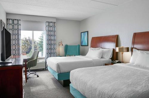 a hotel room with two beds and a window at Hilton Garden Inn Allentown West in Breinigsville