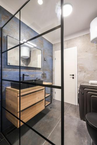 a bathroom with a sink and a mirror at VILLA ARGOLA in Vrsi