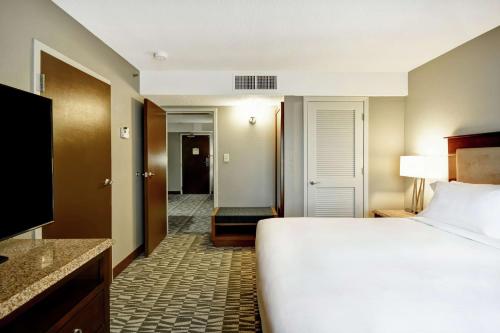 a hotel room with a bed and a television at DoubleTree by Hilton Augusta in Augusta