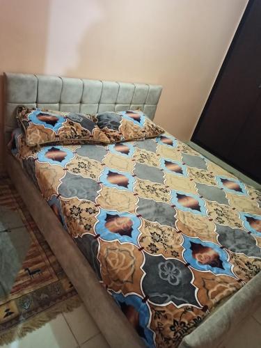 uma cama num quarto com uma colcha com vacas em إقامة الحمد em Meknès