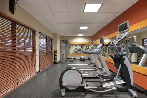 a gym with a treadmill and elliptical machines at Hilton Garden Inn Troy in Troy