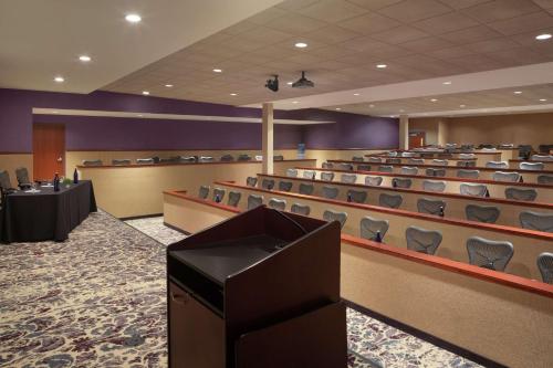 a conference room with rows of chairs and a podium at Hilton Garden Inn Troy in Troy