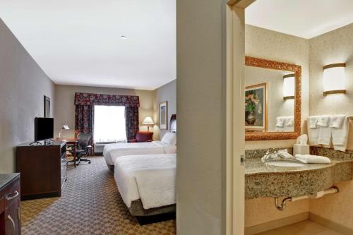 a hotel room with two beds and a bathroom at Hilton Garden Inn Amarillo in Amarillo