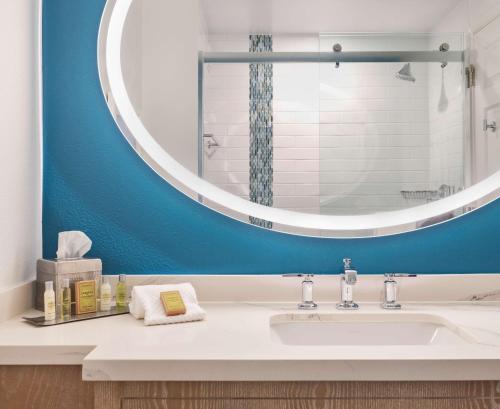 a bathroom with a sink and a large mirror at DoubleTree Suites by Hilton Naples in Naples