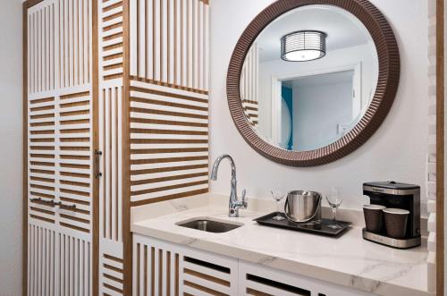 a bathroom with a sink and a mirror at DoubleTree Suites by Hilton Naples in Naples