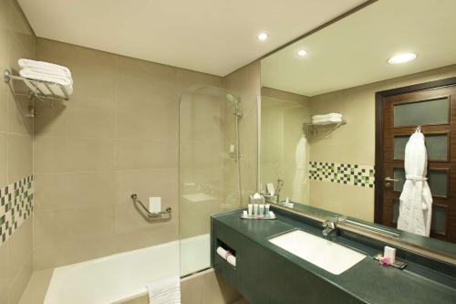 a bathroom with a sink and a shower at DoubleTree by Hilton Hotel Aqaba in Aqaba