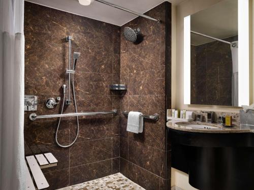 a bathroom with a shower and a sink at Hilton Atlanta Airport in Atlanta