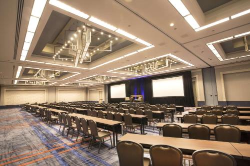a large room with rows of tables and chairs at Hilton Atlanta Airport in Atlanta