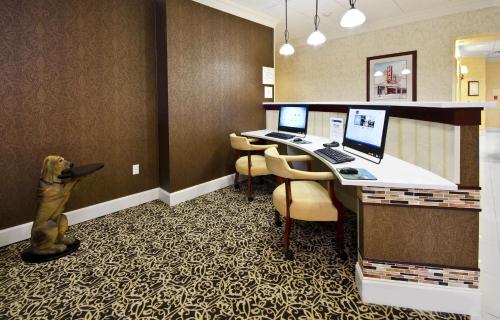 a hotel room with a dog standing in front of a computer at Hampton Inn Lawrenceville Duluth in Lawrenceville