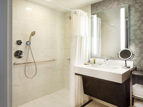 a bathroom with a sink and a shower at Hilton Atlanta/Marietta Hotel & Conference Center in Marietta