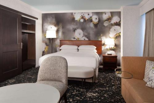 um quarto de hotel com uma cama e duas cadeiras em Hilton Atlanta/Marietta Hotel & Conference Center em Marietta