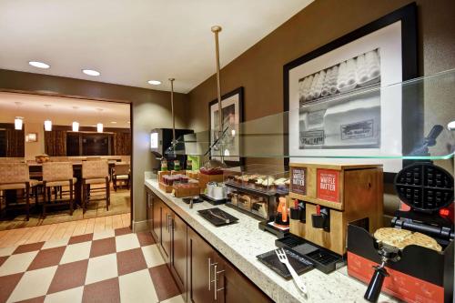 a kitchen with a counter and a dining room at Hampton Inn Atlanta-Mall Of Georgia in Buford