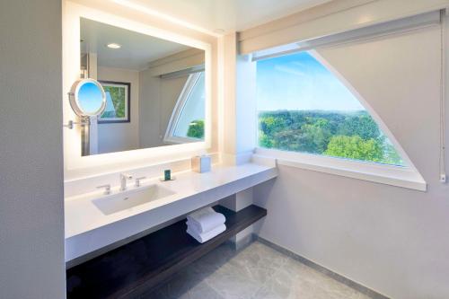 a bathroom with a sink and a large window at DoubleTree by Hilton Atlanta/Roswell - Alpharetta Area in Roswell