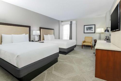 a hotel room with two beds and a desk at DoubleTree by Hilton Austin-University Area in Austin
