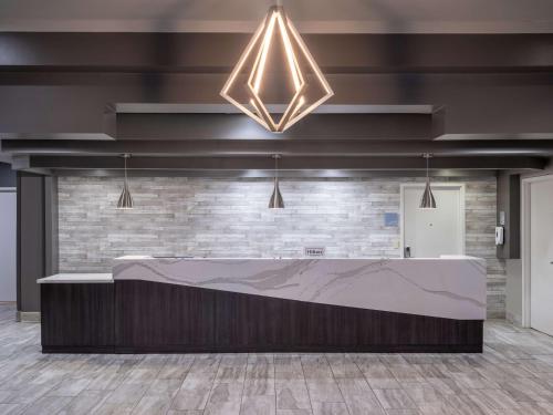 a lobby with a reception desk in a brick wall at Embassy Suites Baltimore - North/Hunt Valley in Hunt Valley