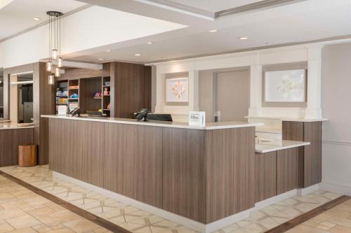 a lobby with a reception counter in a building at Hilton Garden Inn Boca Raton in Boca Raton