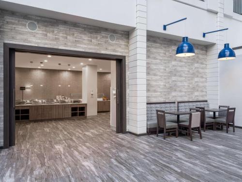 a dining room with tables and chairs and blue lights at Embassy Suites Baltimore - North/Hunt Valley in Hunt Valley