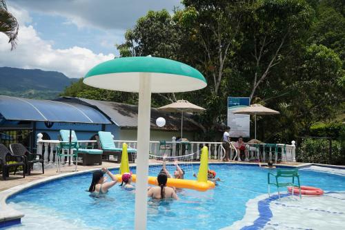a group of people playing in a swimming pool at Villeta Boutique Hotel Spa in Villeta