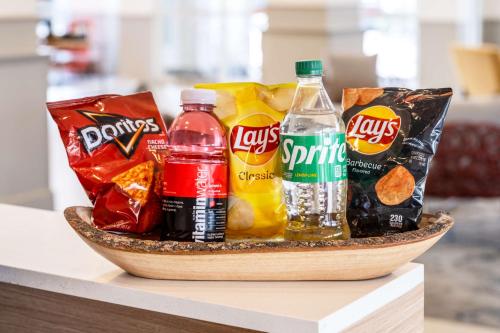 a basket of snacks and drinks on a table at Hilton Garden Inn Bakersfield in Bakersfield
