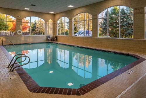 a large swimming pool in a building with windows at Hilton Garden Inn Boise Spectrum in Boise