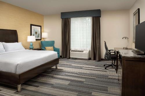 a hotel room with a bed and a desk at Hilton Garden Inn Murfreesboro in Murfreesboro