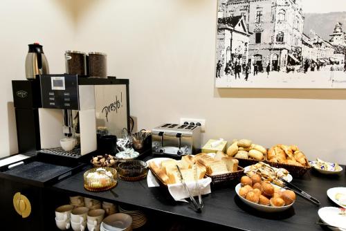 a table filled with bread and pastries on top at Prinz Gregor in Braşov