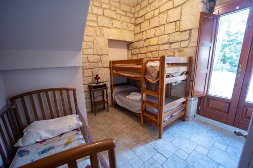 a room with two bunk beds and a window at Casale Della Contea in Modica