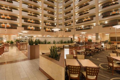 a restaurant with tables and chairs in a large building at Embassy Suites by Hilton Nashville South Cool Springs in Franklin