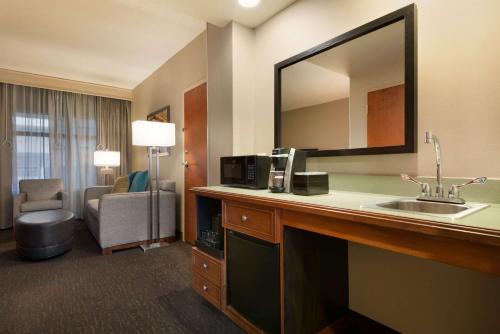 a hotel room with a sink and a mirror at Embassy Suites by Hilton Franklin Cool Spring in Franklin
