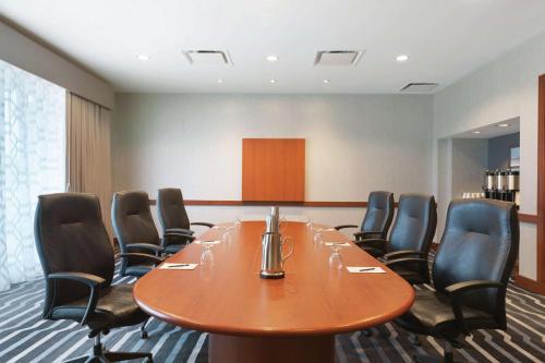 a conference room with a wooden table and chairs at Hilton Boston Logan Airport in Boston