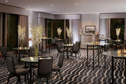 a restaurant with tables and chairs in a room at Hilton Boston Logan Airport in Boston