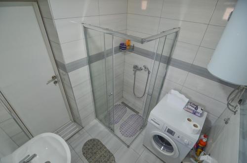 a small bathroom with a shower and a toilet at Planinska Oaza in Pale