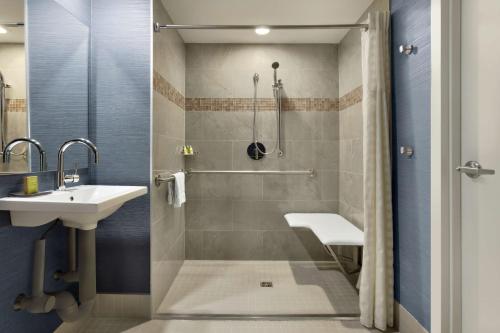 a bathroom with a shower and a sink at DoubleTree Suites by Hilton Hotel Boston - Cambridge in Boston