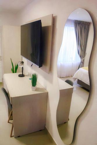 a room with a mirror and a bedroom with a bed at BLISS BOUTIQUE HOTEL BOGOTA in Bogotá