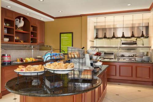 a kitchen with a table with food on it at Hilton Garden Inn Bartlesville in Bartlesville