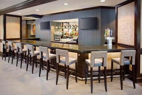 a bar with a row of bar stools at DoubleTree by Hilton Baltimore - BWI Airport in Linthicum Heights