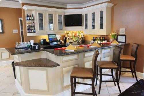 a bar in a hotel room with chairs and a counter at Hilton Garden Inn Aberdeen in Aberdeen